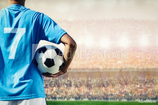 Picture of soccer football player in blue team concept holding soccer ball